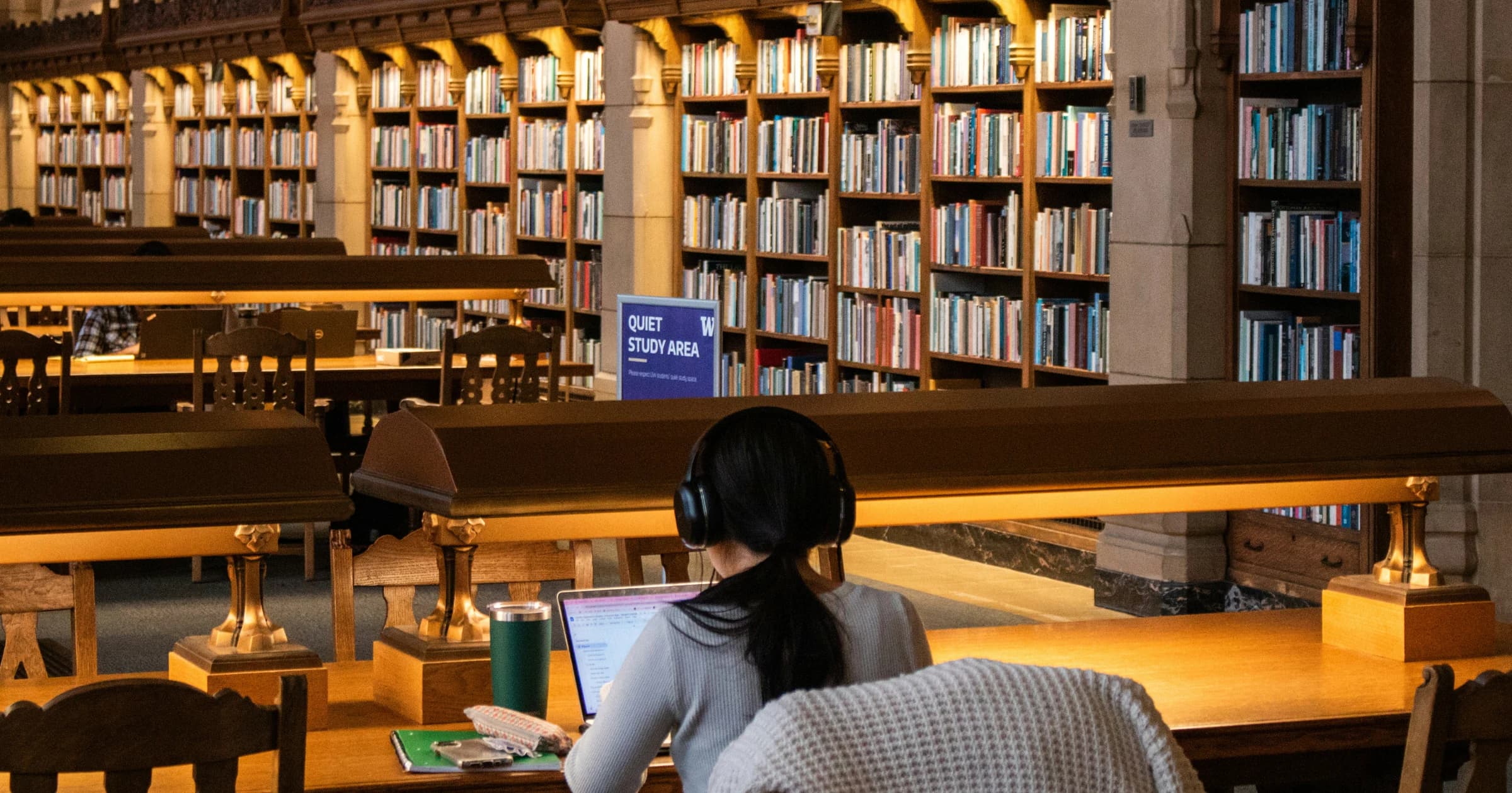 A student studies at a laptop in the University of Washington's Suzzallo Library.