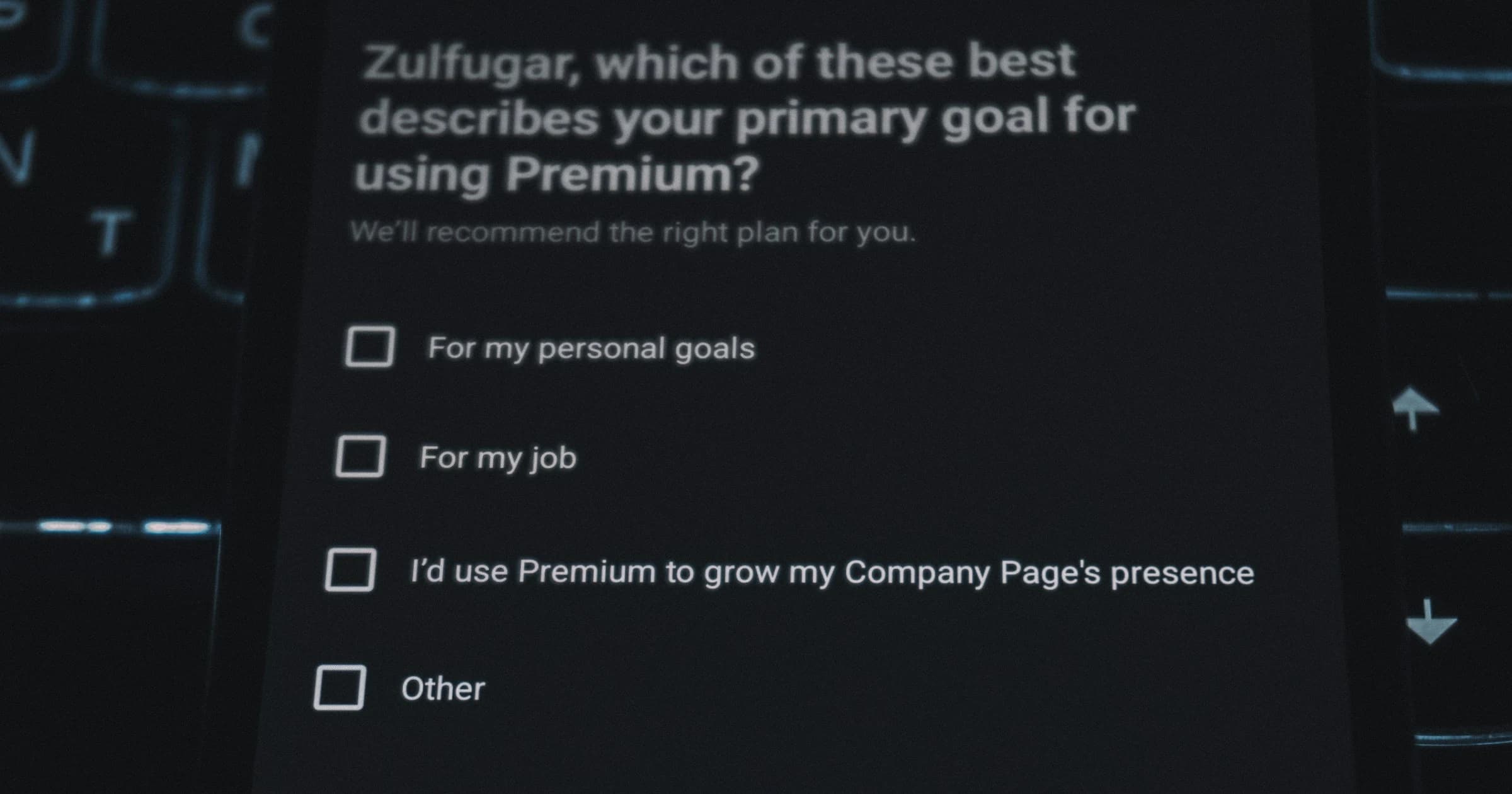 A laptop screen shows a multiple-choice question about a respondent’s goals.