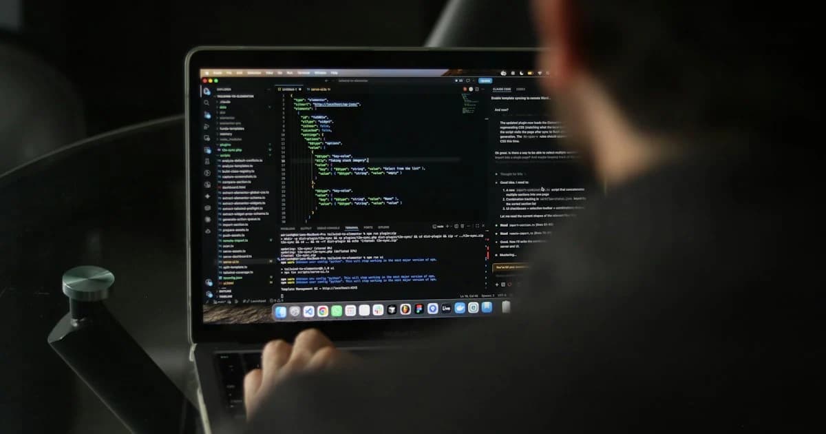 A developer works at a laptop with source code visible.