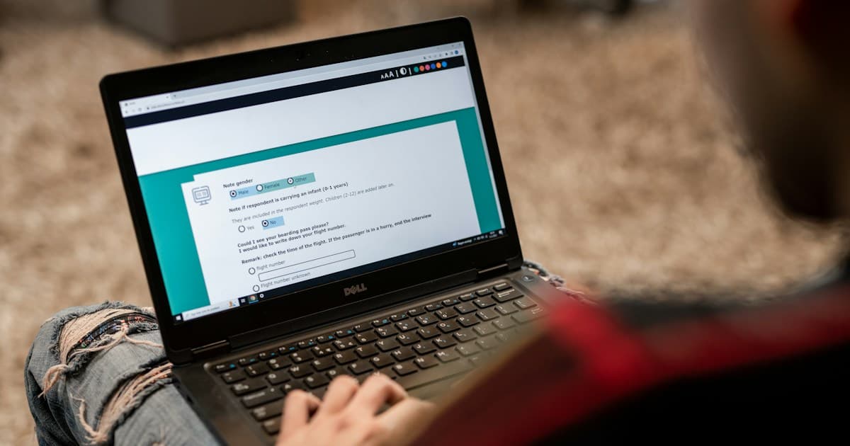A respondent completes a survey questionnaire on a laptop.