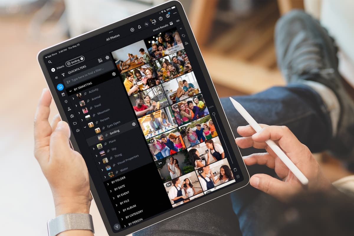 Mylio Photos on a tablet showing an All Photos gallery with SmartTags and QuickFilters controls.