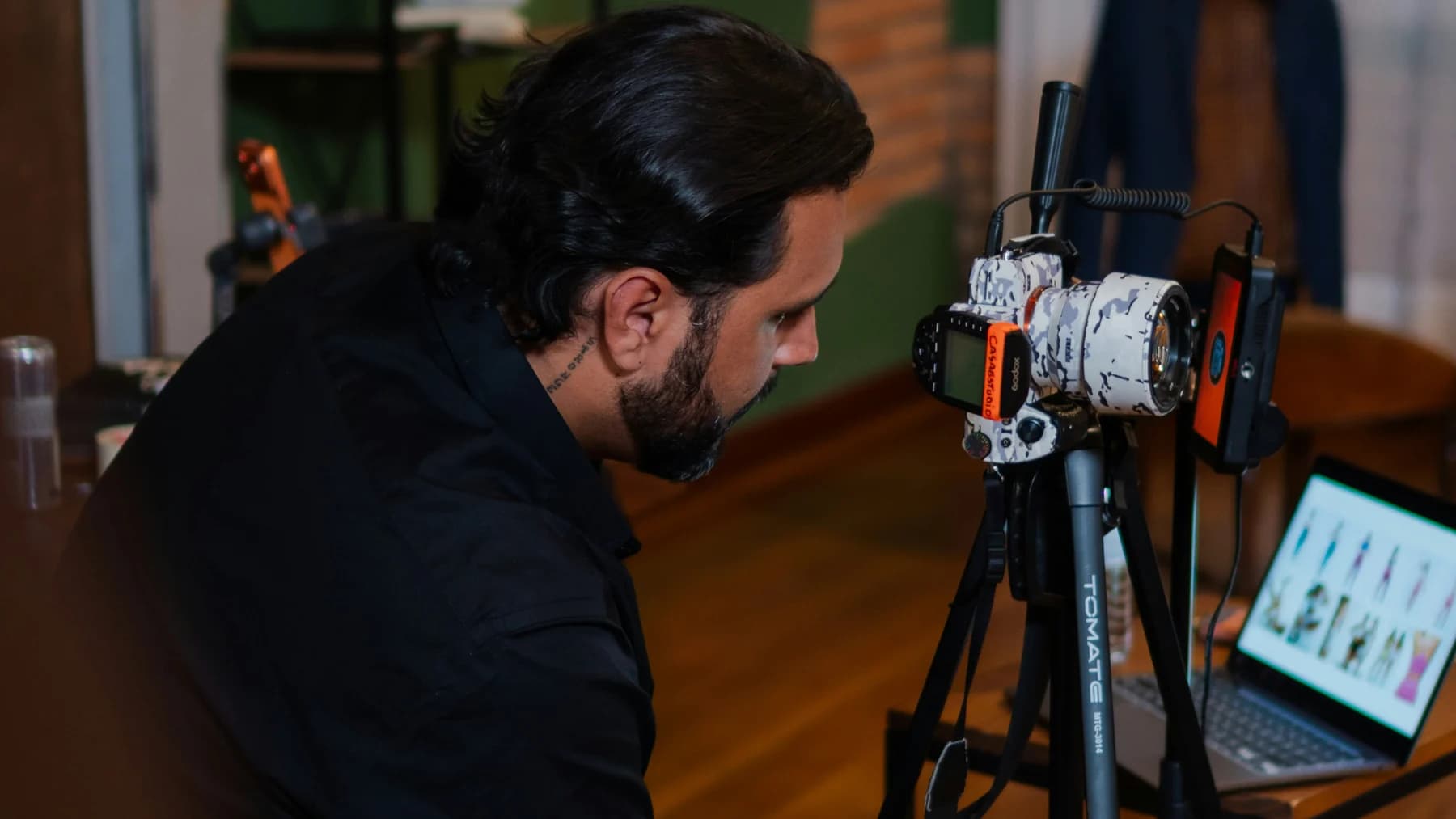 A person operates a camera while filming.